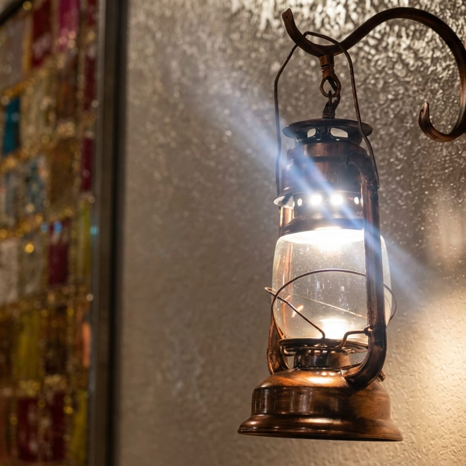 Antique lantern glowing on a textured wall beside a colorful stained-glass window.